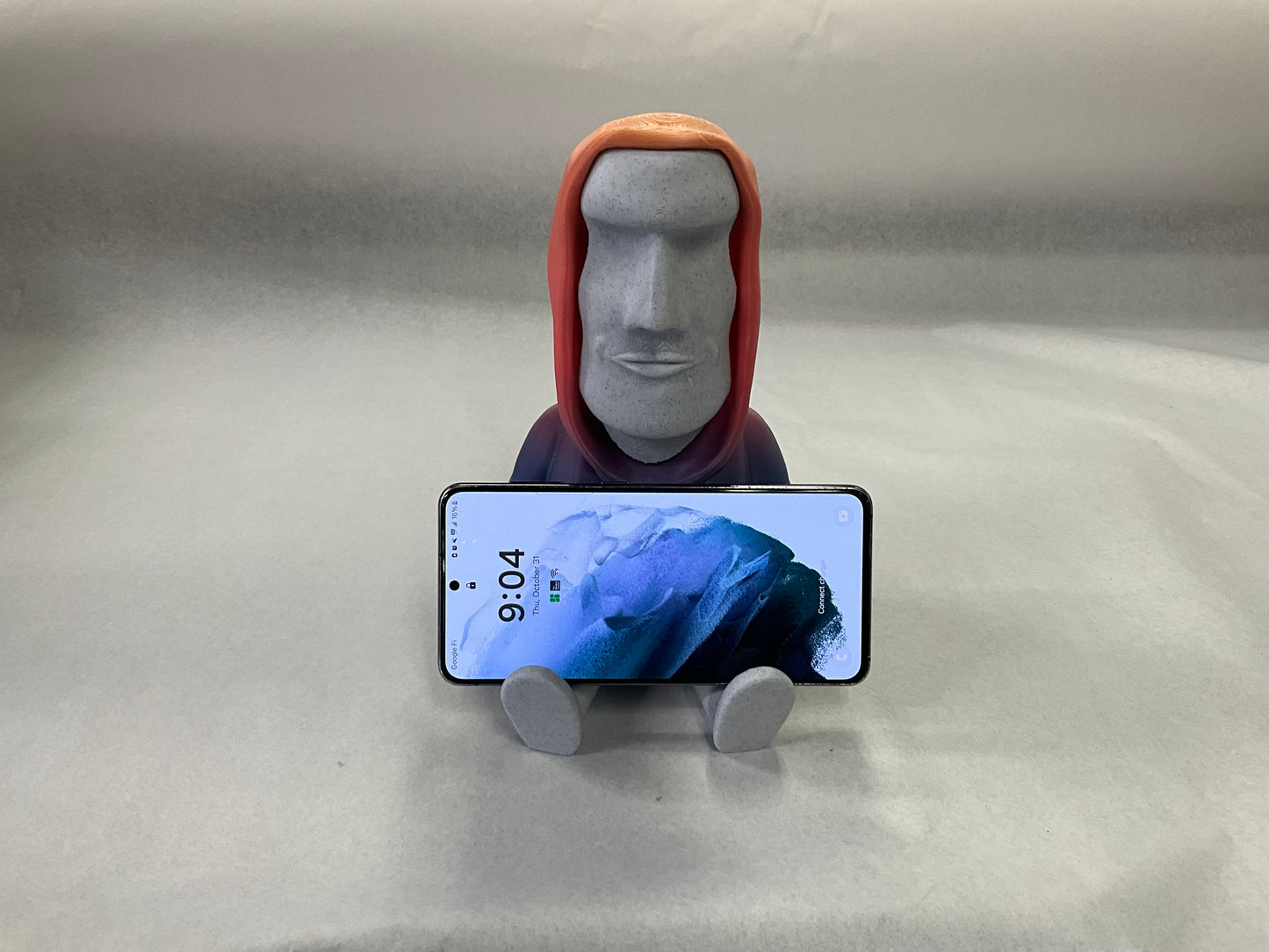 3D Printed Easter Island Head Device Holder with Rainbow Hoodie – Fun Stand for Nintendo Switch, Smartphone, and More!