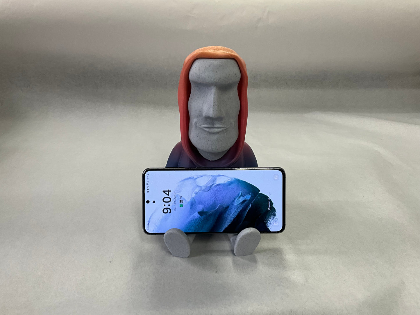 3D Printed Easter Island Head Device Holder with Rainbow Hoodie – Fun Stand for Nintendo Switch, Smartphone, and More!