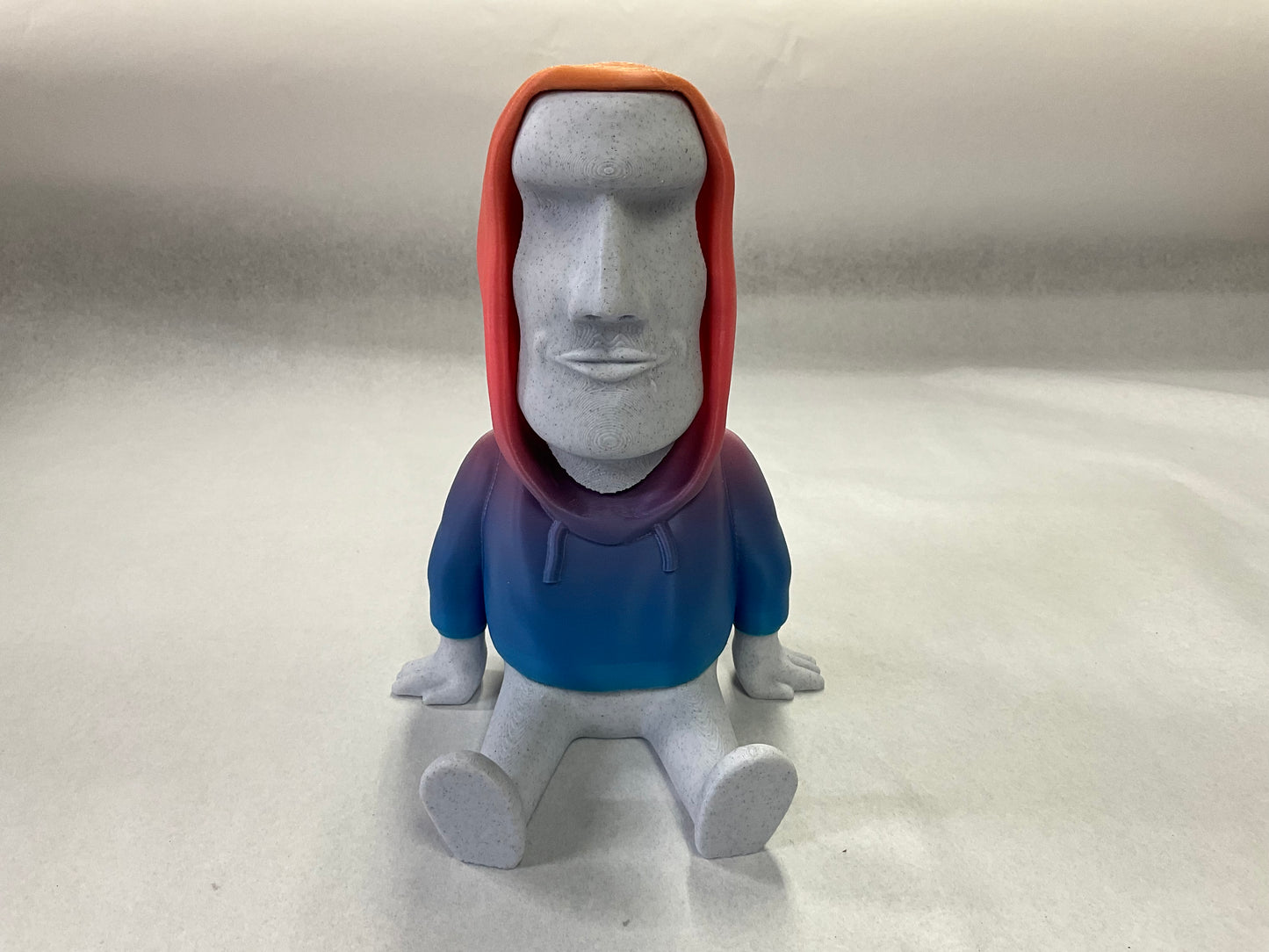 3D Printed Easter Island Head Device Holder with Rainbow Hoodie – Fun Stand for Nintendo Switch, Smartphone, and More!