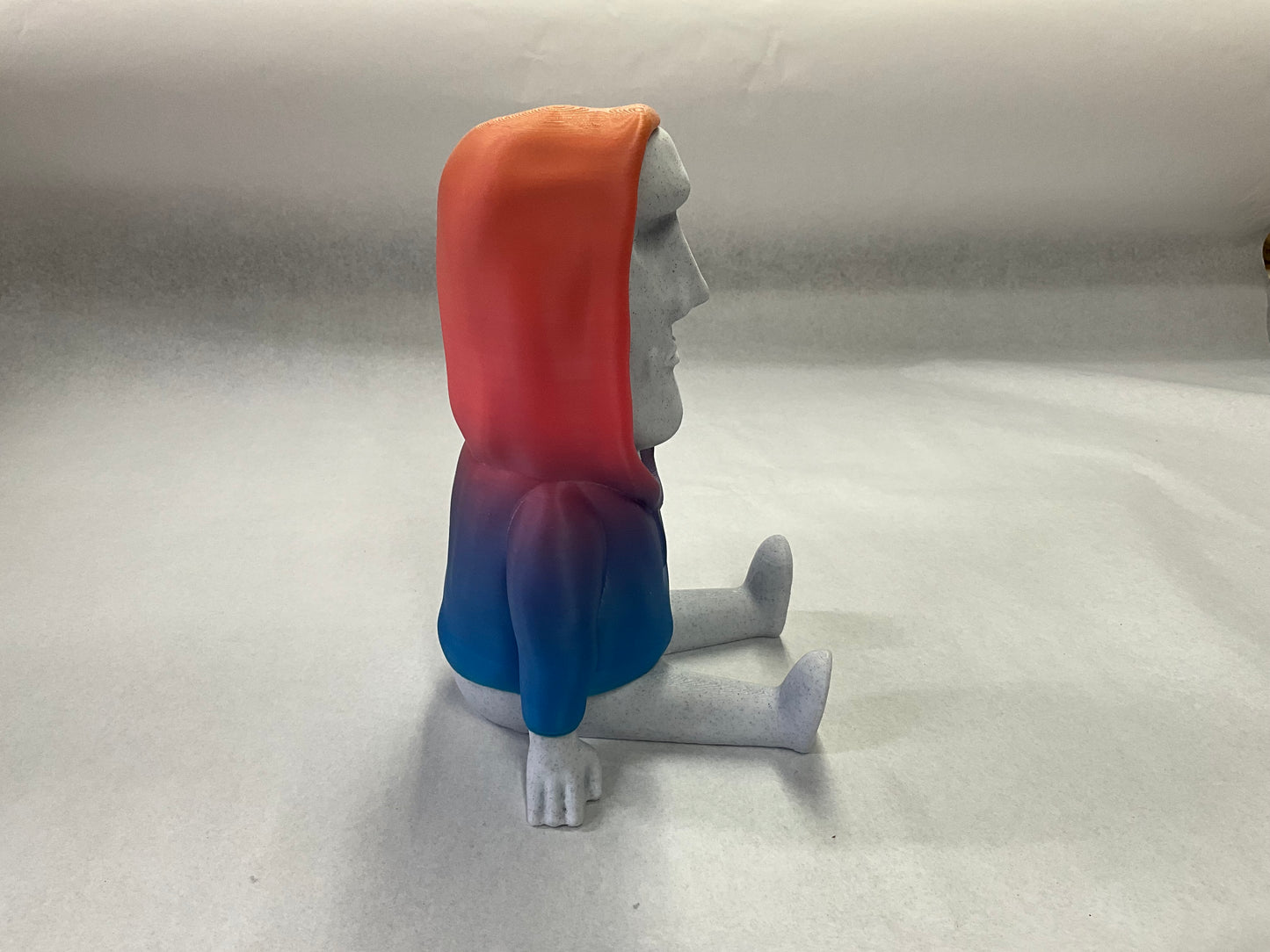 3D Printed Easter Island Head Device Holder with Rainbow Hoodie – Fun Stand for Nintendo Switch, Smartphone, and More!