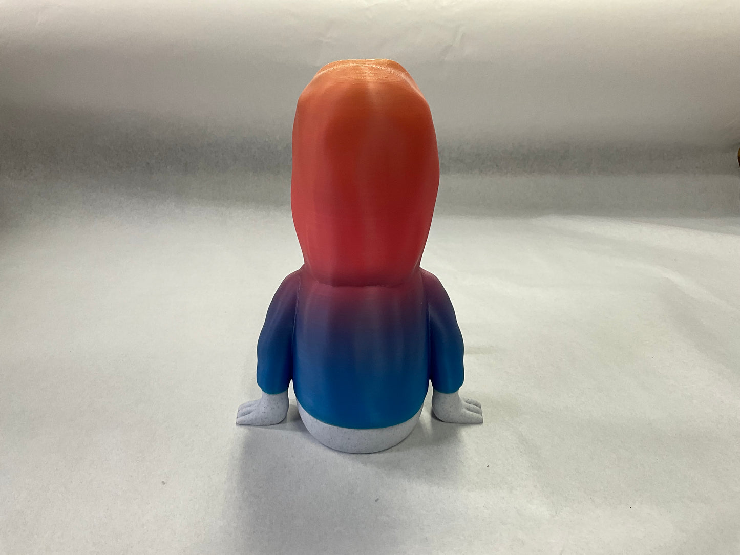 3D Printed Easter Island Head Device Holder with Rainbow Hoodie – Fun Stand for Nintendo Switch, Smartphone, and More!