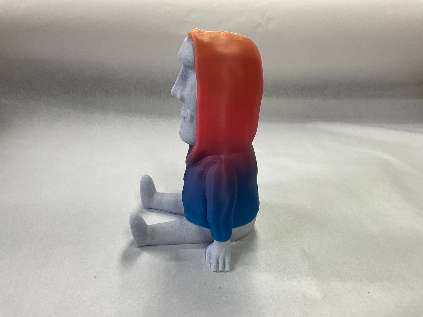 3D Printed Easter Island Head Device Holder with Rainbow Hoodie – Fun Stand for Nintendo Switch, Smartphone, and More!